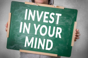 Invest in your mind text written on chalkboard