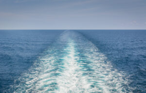 open ocean with a boat's wake. "Looking back"