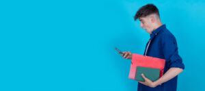 student with mobile phone isolated on blue background
